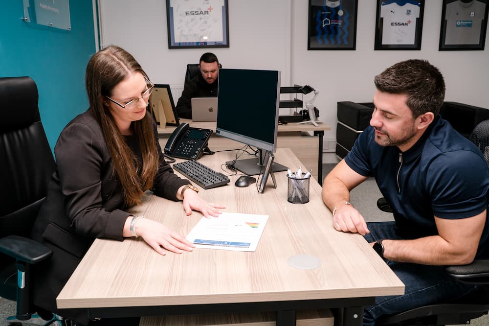 Two people filling in a tenant background check form